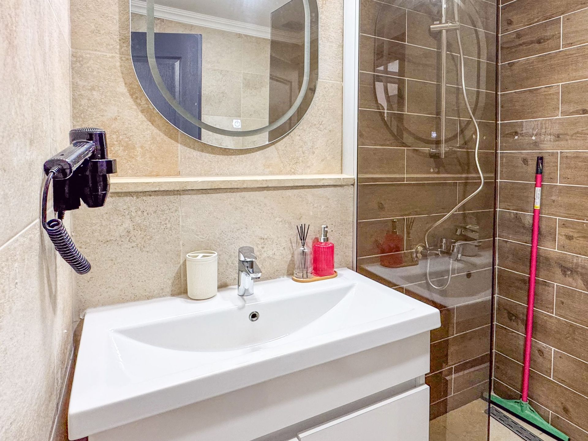 Bathroom with vanity and glass walk-in shower enclosure