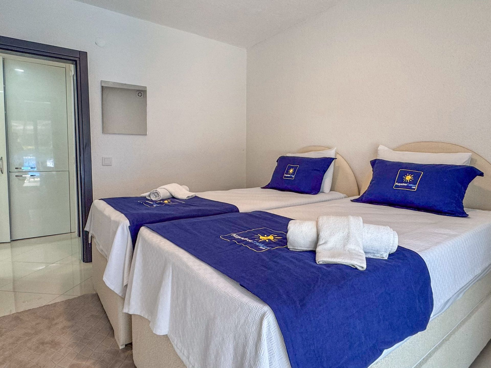 Twin bedroom with two single beds prepared for guests